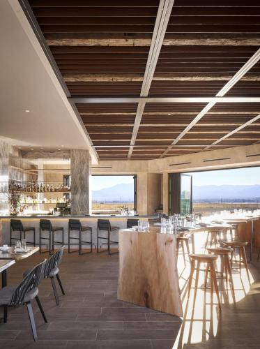 a restaurant with tables and chairs and a bar at Hotel Chaco in Albuquerque