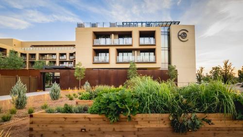 a building with a garden in front of it at Hotel Chaco in Albuquerque