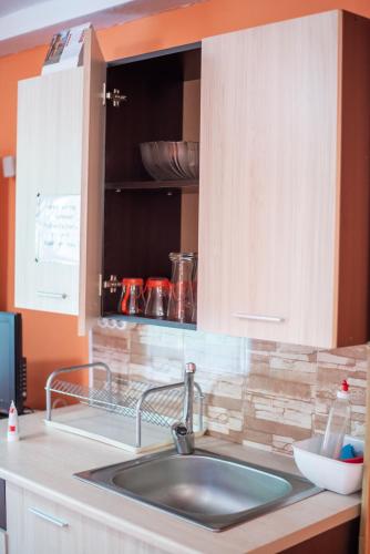 a kitchen with a sink and a counter top at Danailovi Guest House in Sapareva Banya