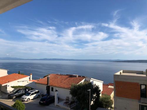 a view of a large body of water between buildings at Guest House Stipe in Brela