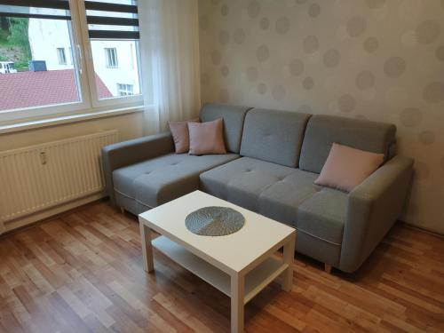 a living room with a couch and a table at Apartmán Tereza in Kraslice