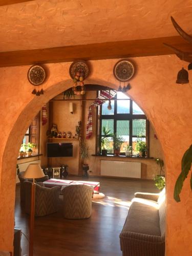 a living room with an archway in a house at Prutets Guest House in Tatariv