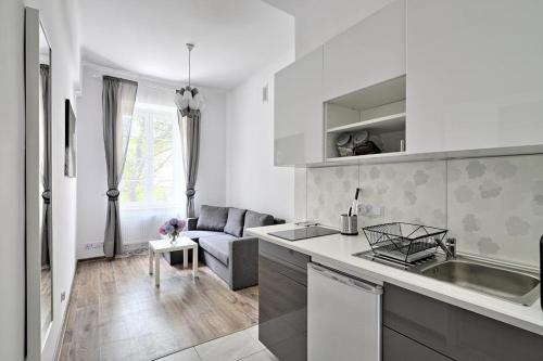 a kitchen and living room with a couch and a table at Apartament w centrum :) in Krakow