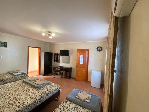 a hotel room with two beds and a desk at Aquamarin in Zatoka