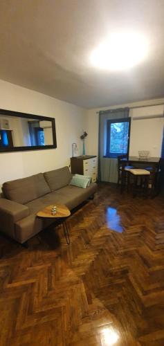a living room with a couch and a table at Apartment Terra in Mali Lošinj