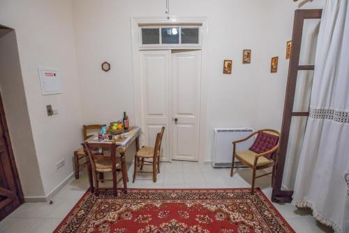 a dining room with a table and chairs and a door at Iosiphis Stonebuilt House in Pano Lefkara