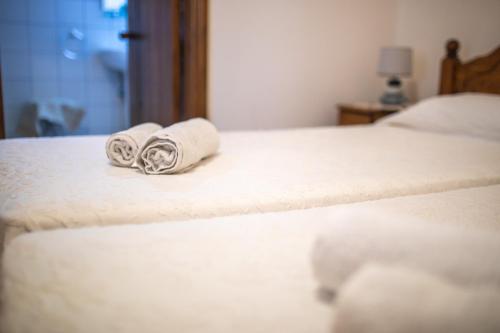 two towels are sitting on top of two beds at Iosiphis Stonebuilt House in Pano Lefkara