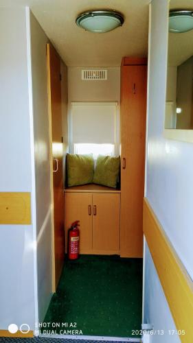a small room with a bench in a room at Gina's Static caravan,118 Sandsgate in Hemsby