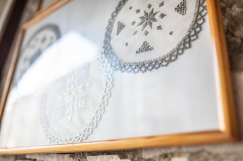 a picture frame with a rosary on a shelf at Iosiphis Stonebuilt House in Pano Lefkara