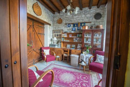 a dining room with a table and chairs in a room at Iosiphis Stonebuilt House in Pano Lefkara