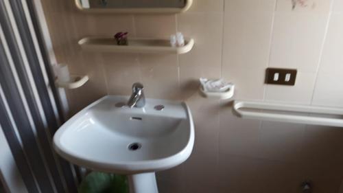 łazienka z białą umywalką i toaletą w obiekcie Locanda Ermes w Capaccio-Paestum