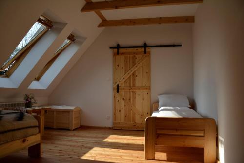 a bedroom with a barn door in a attic at Michniowiec 6 in Czarna