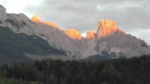 a group of mountains with the sun shining on them at Ferienwohnung Wohlesser in Annaberg im Lammertal