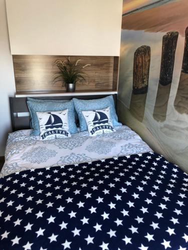 Cama ou camas em um quarto em Apartament Baltik Star