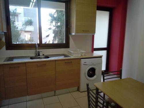 a kitchen with a sink and a washing machine at 3 Bedroom Apartment in Nicosia