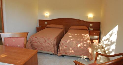 Tempat tidur dalam kamar di Hotel Giardino