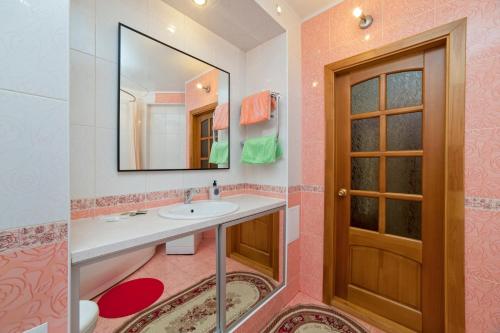 a bathroom with a sink and a mirror at Apartments on Kuznechnaya 79 in Yekaterinburg