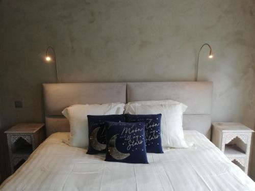 a bedroom with a white bed with two night stands at Wellness Sweet Bonihu B&B in Bruges