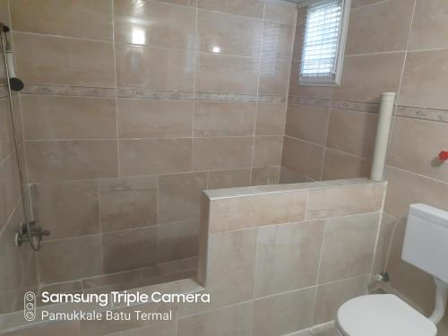 a bathroom with a shower with a toilet at Pamukkale Batu Termal in Pamukkale