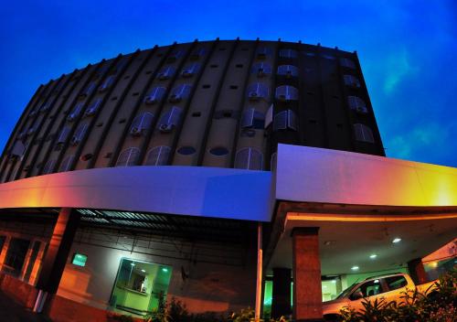 a building with a car parked in front of it at Biss Inn Hotel in Goiânia