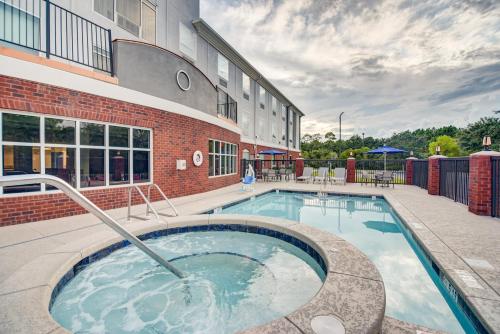 a swimming pool in front of a building at Holiday Inn Express Hotel & Suites Foley by IHG in Foley