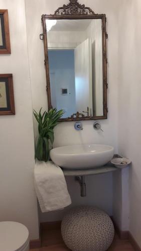a bathroom with a sink and a mirror at Le Stanze del Cardinale in Pavia