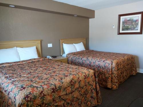 a hotel room with two beds in a room at Arnprior Motor Inn in Arnprior
