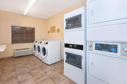 a laundry room with washers and dryers at Candlewood Suites Rocky Mount by IHG in Rocky Mount