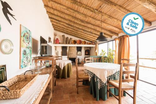 a kitchen and dining room with a table and chairs at Horta da Quinta in Mértola