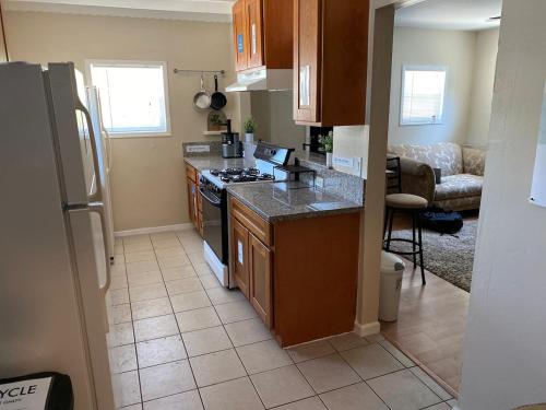 a kitchen with wooden cabinets and a stove top oven at WHOLE Family - Barrette in Sacramento