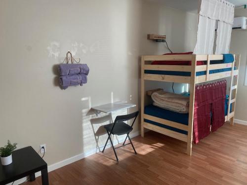 a bedroom with bunk beds with a desk and a chair at WHOLE Family - Barrette in Sacramento