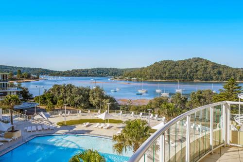 a view of the water from the balcony of a resort at Ettalong Beach Luxury Apartments in Ettalong Beach