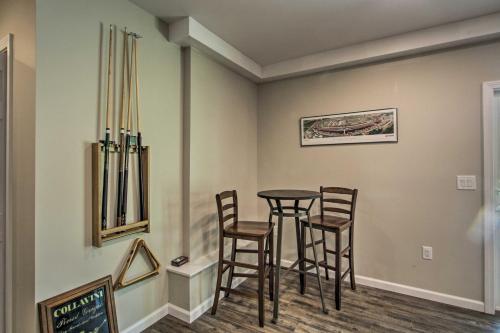 a dining room with a table and stools at Covered Deck, Grill and Game Room Gilford House! in Gilford