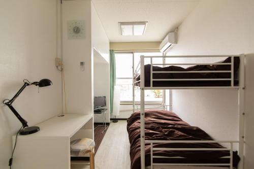 a bedroom with a bunk bed and a desk with a lamp at Chiba Breen hills Inage #8Mx in Chiba