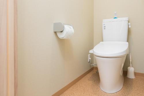 a bathroom with a toilet with a roll of toilet paper at Juso AFP Apartment Hotel in Osaka