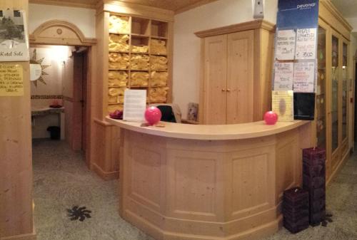 a bar in a wine cellar with wooden cabinets at Hotel Sole in Passo del Tonale