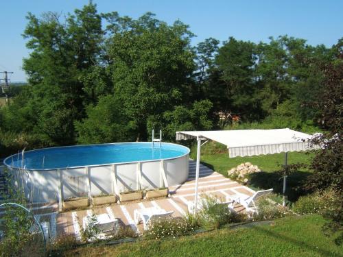 a swimming pool in a yard with a pavilion at Chambres d'Hôtes Domaine d'En Baleux in Labruguière