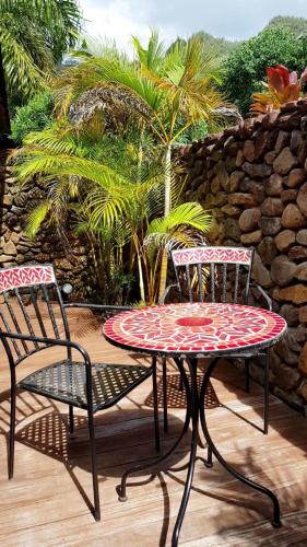 two chairs and a table and a table and chairs at Villa Anuanua by Tahiti Homes in Papetoai