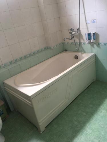 a bath tub with a faucet in a bathroom at Thien Anh Hotel in Hai Phong
