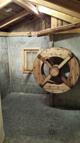 a wooden wheel in a room with a window at Hotel Sole in Passo del Tonale