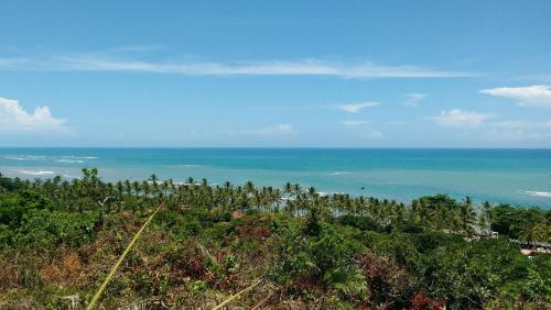 a view of the ocean from the top of a hill at Charm Bahia Residencias in Arraial d'Ajuda