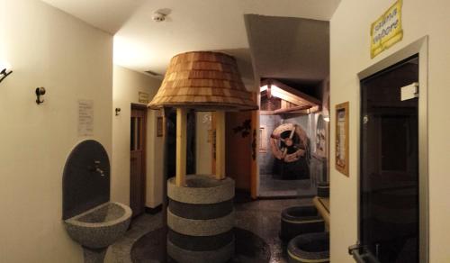 a room with a hallway with a room with a lamp at Hotel Sole in Passo del Tonale