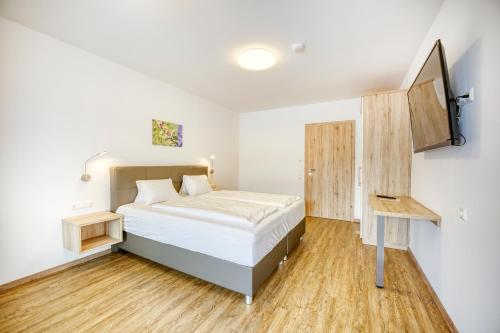 Ένα ή περισσότερα κρεβάτια σε δωμάτιο στο Ferienwohnungen Petschnig 1