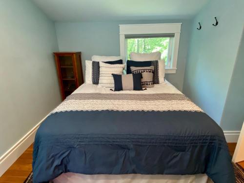a bedroom with a large bed with pillows on it at Newly Renovated 3BR Hudson Valley House in Ulster Park