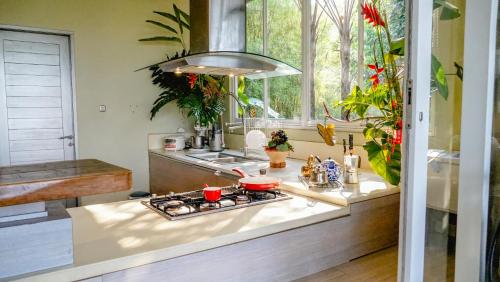 a kitchen with a stove and a sink at Ruth's Bed & Breakfast in Lembang