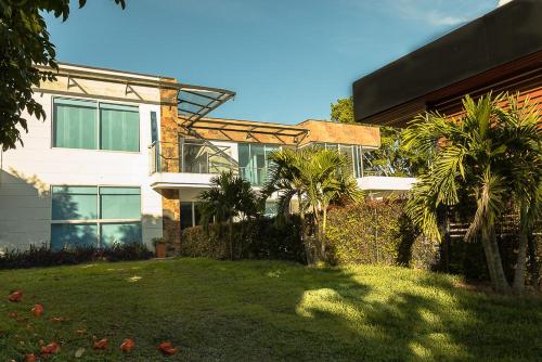 a house with palm trees in front of it at Libertg Hotels Spa in Copacabana