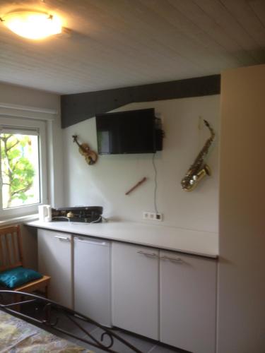 a kitchen with a counter with instruments on the wall at B&B Aalsters genot in Aalst