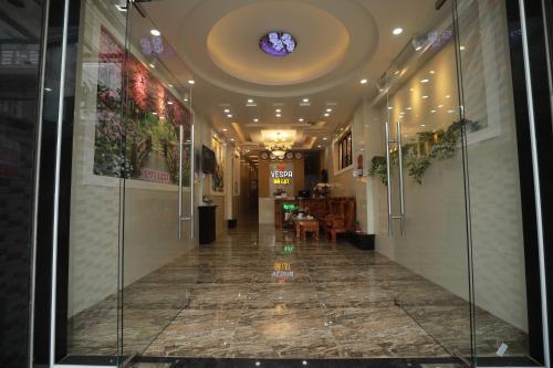 a hallway of a building with glass doors and a ceiling at VES - PA Luxury Hotel in Da Lat