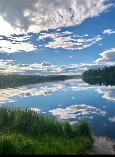 a view of a lake with clouds in the sky at Villa Karhunkehto in Luosto