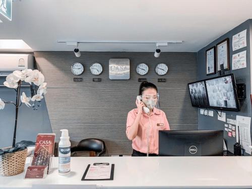 a man talking on a cell phone in an office at Casa Residence Hotel in Bangkok
